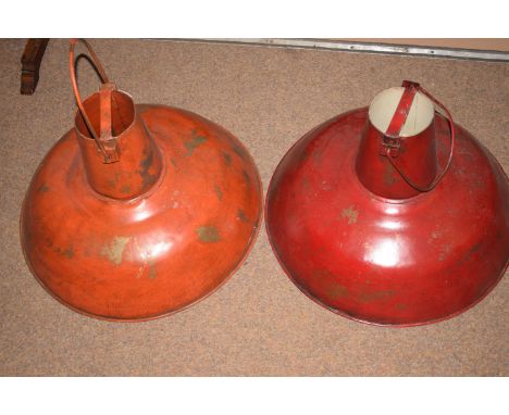 A pair of industrial Art Deco style ceiling light fittings in red and orange.