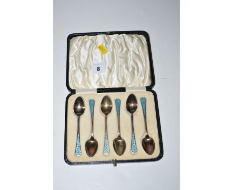 A set of six silver teaspoons with light blue enamel finials, in fitted case.