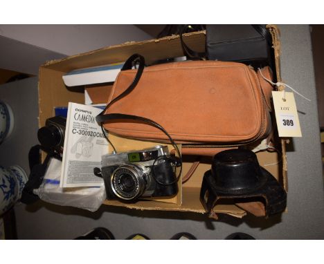 An Olympus Camedia digital camera with accessories in original box; a Cannon ZW pocket camera; a Minolta Vectus 200 pocket ca