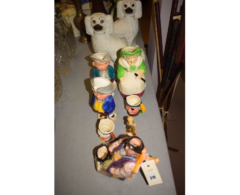 A pair of Staffordshire dogs; Burlington toby jugs; Melba ware toby jug of Henry VIII; Royal Doulton character jug of Anne of