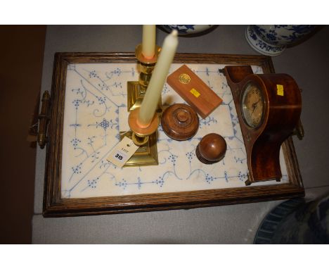 A mantel clock in inlaid case; three pieces of wooden treen; a pair of brass candlesticks; and a rectangular tray with blue a