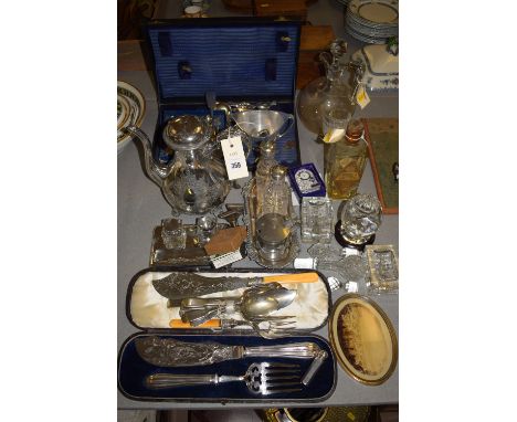A quantity of miscellaneous plated cutlery; servers; fish servers; condiment bottles; glassware; a small old bottle of Gilbey