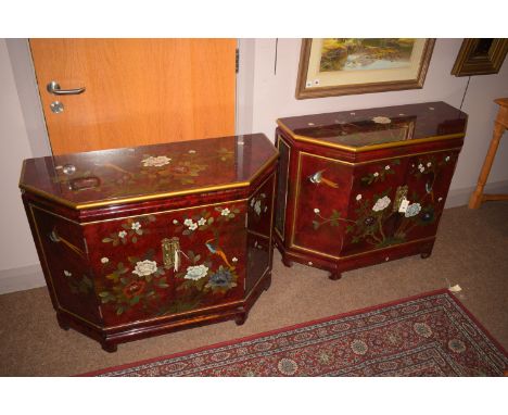 A pair of Asian red lacquer type chinoiserie side cabinets, decorated with flowering peonies and exotic birds, each fitted a 