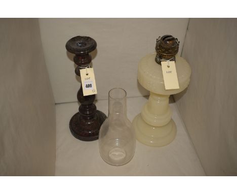 A turned and polished marble candlestick; together with an opaque glass table oil lamp with clear glass chimney.