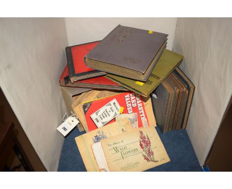A collection of cigarette cards by Wills; John Player & Sons; to include flags; crests; flowers; architecture; ornithology; c