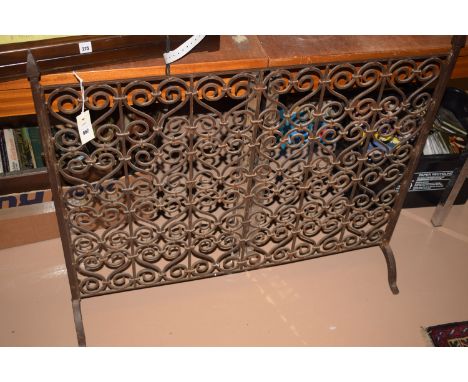 A wrought iron firescreen.
