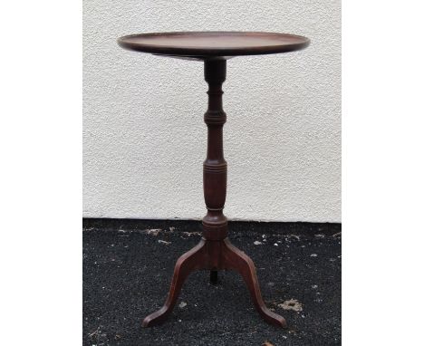 A Georgian mahogany and beechwood occasional table, the circular dished top 44 cm diameter raised on a turned pillar and trip