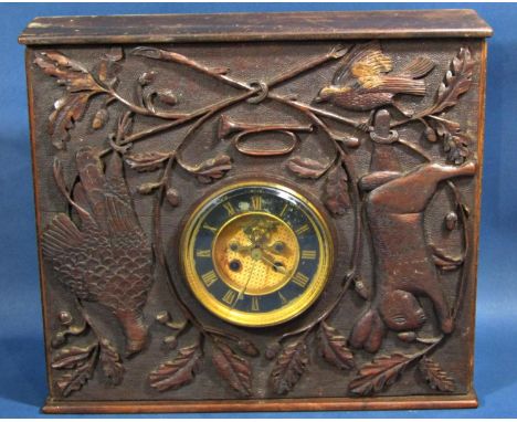 A Victorian clock movement with eight day striking mechanism and visible escapement, set in a carved hardwood case showing ha