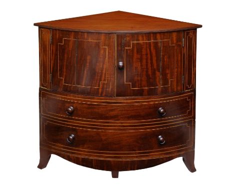 A Georgian mahogany corner commode with rising lid, with bowfronted outline, the front elevation enclosed by a pair of doors 