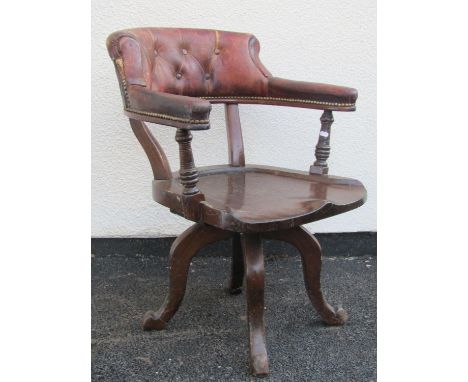 A late 19th century office chair in mahogany with saddle shaped seat, original tan coloured leather horseshoe shaped back rai