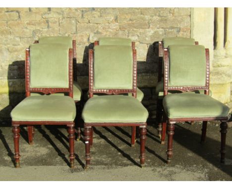 A set of six Victorian dining chairs with light sage green upholstered seats and swept and rolled backs and mahogany showwood