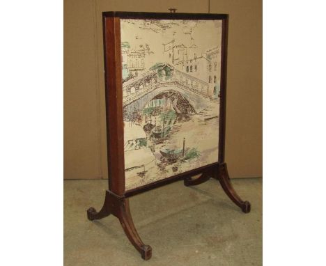A Regency mahogany firescreen with rise and fall upholstered panels raised on swept supports with inlaid detail, 58 cm wide x