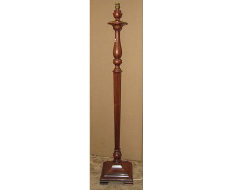 A mahogany standard lamp with partially turned and hexagonal tapered stem raised on a swept and stepped square platform base,