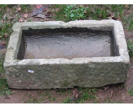 A small weathered rectangular trough with dished interior, 54 cm long x 36 cm wide x 15 cm deep 