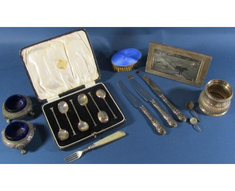 A cased set of six coffee spoons, two Victorian salt cauldrons, a silver beaker, a silver photo frame, a blue enamelled brush