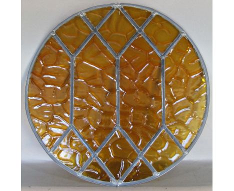 An art deco leaded light panel with amber coloured glass, 51cm diameter, with travel case 