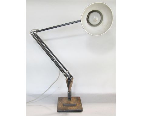 A Herbert Terry Anglepoise lamp set on a black two tier square cut base. 