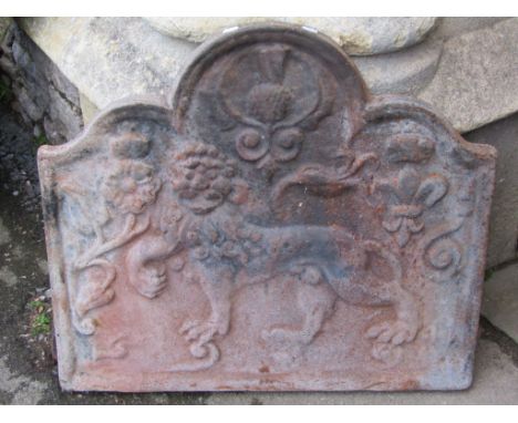 A heavy cast iron fire back of rectangular stepped arched form with lion, thistle and fleur-de-lys detail, 76 cm wide x 66 cm