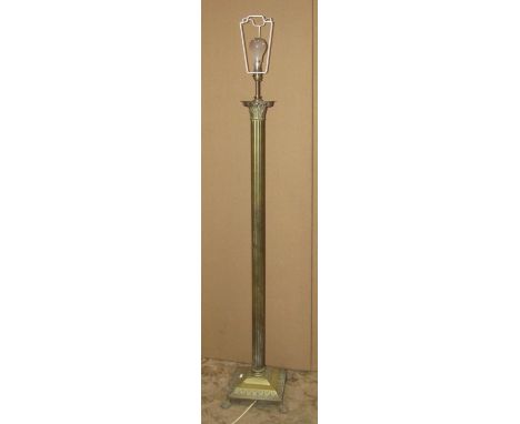 A cast brass standard lamp in the form of a Corinthian column raised on a square stepped and swept base with lions paw feet, 