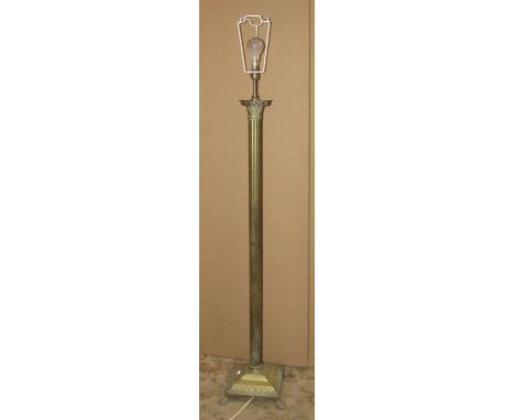 A cast brass standard lamp in the form of a Corinthian column raised on a square stepped and swept base with lions paw feet, 