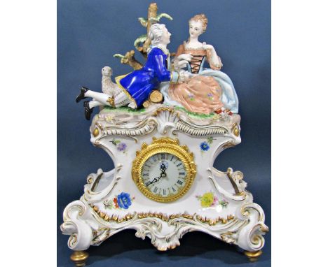A contemporary porcelain mantle clock in the romantic style, surmounted by male and female characters with sheep, the rococo 