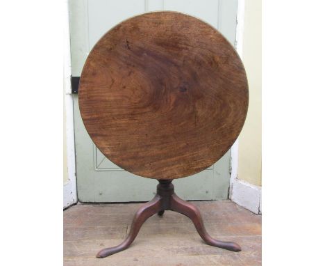 A Georgian mahogany snap top occasional table, the circular one piece top 81cm with bird cage action raised on a turned pilla