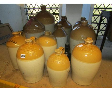 A collection of vintage stoneware flagons varying capacity, five with impressed merchants marks to include a local Wotton-und