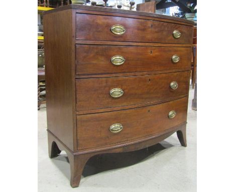 A Regency mahogany caddy top bow fronted chest of four long graduated drawers with shaped apron and splay bracket supports 10