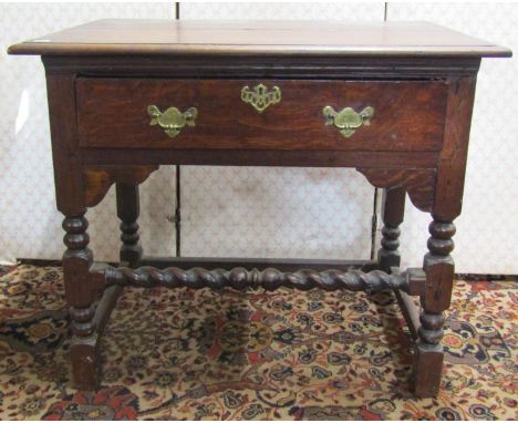 An antique oak side table with frieze drawer raised on bobbin moulded supports with barley twist rails, 80cm wide 