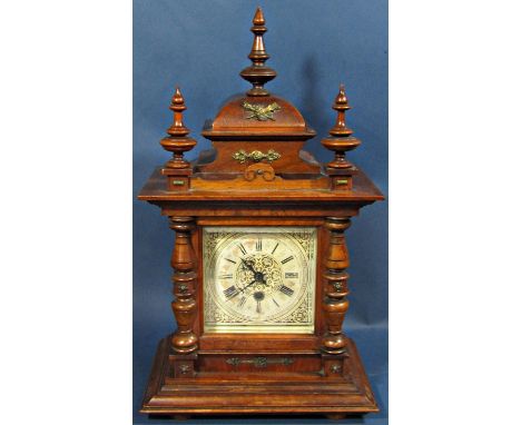 Late 19th century walnut mantle clock, the case of architectural form with turned spindle mouldings enclosing a square dial a