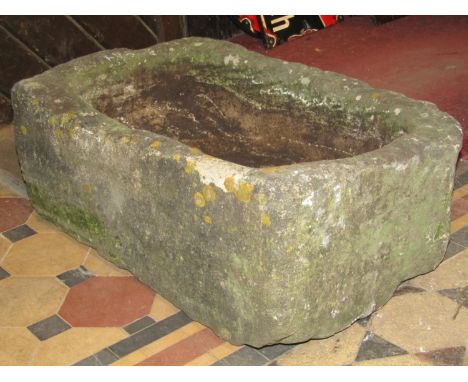 A weathered thick walled rectangular natural stone trough with circular drainage hole 76 cm long x 46 cm wide x 28 cm high 