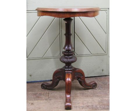 A Victorian occasional table, the circular figured walnut top with segmented veneers, raised on a carved vase shaped pillar a