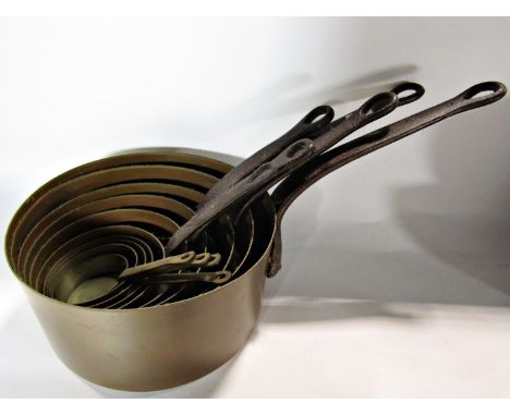 A set of eleven graduated copper saucepans with steel handles, pewter mugs, ships decanter, collection of napkin rings, etc 