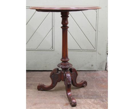 A Victorian walnut and figured walnut occasional table, the circular top with simple scrolling marquetry detail raised upon a