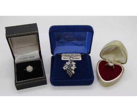 Group of jewellery comprising a 9ct cubic zirconia solitaire ring, a further dress ring and a silver sapphire spray pendant n