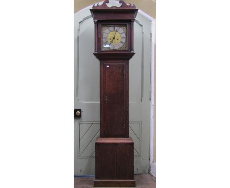 A Georgian oak country made longcase clock, with column supports enclosing a square brass dial with silvered chapter ring and