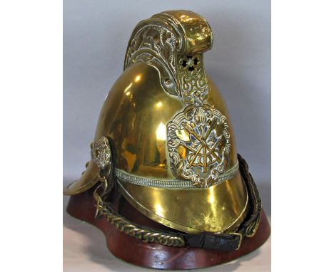 A Victorian Merryweather fireman's helmet in brass with ornate comb detailing a fire breathing dragon, formerly used by the W