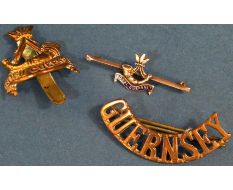 Royal Guernsey Light Infantry cap bade, shoulder badge and a gold bar brooch 