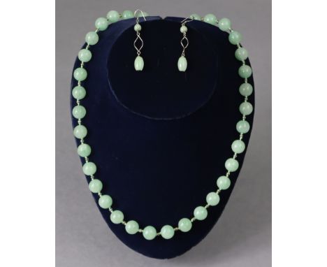 A jade necklace with gilt-metal clasp, 22” long; &amp; a pair of jade earrings.