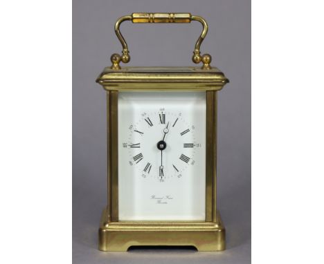 A modern brass-cased carriage timepiece with black roman numerals to the white enamel dial, 4¾" high.