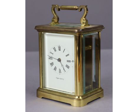 A Mappin &amp; Webb large brass-cased carriage timepiece with black Roman numerals to the white enamel dial, 5½” high.