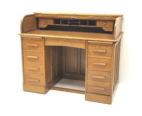 Early 20th century light oak twin pedestal tambour roll top desk, fitted interior, two slides, single frieze flanked by eight