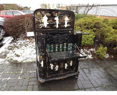 A Chinese drinks cabinet with fully fitted interior decorated with depictions of Oriental Girls of mother-of-pearl and soapst