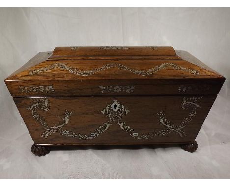 A late 18th / early 19th Century rosewood sarcophagus tea caddy with mother of pearl inlay, fitted with removable lidded cani