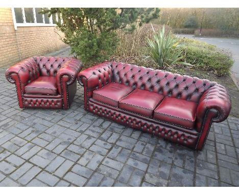 A cherry red Chesterfield three-seater sofa and a single chair to match - (2)