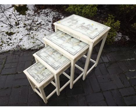 A nest of four rectangular tables of Oriental design with applied mother-of-pearl and soapstone decoration beneath inset plat