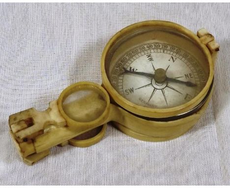 A compass, the face marked Germany with carved case and handle and magnification lenses and mirror verso, 8.5cm (l) Est £30 -
