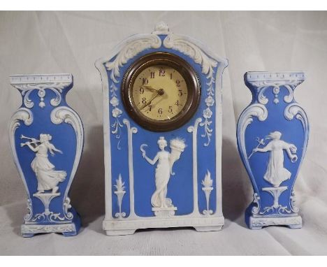 A Schafer & Vater blue Jasperware mantel clock garniture, early 20th century, featuring a classical Roman or Greek lady holdi