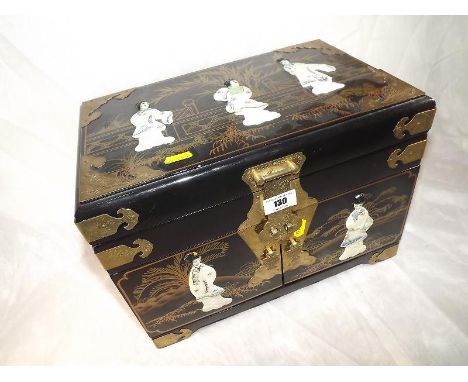 An Oriental jewellery box decorated with mother-of-pearl on a black lacquered ground, with red felt lined fitted interior 
