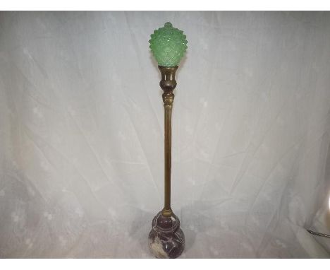 A doorstop the brass stem with pink marble base and green glass finial, 61cm (h)